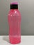 Image of pink water bottle by Tupperware brand isolated on grey background.