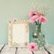 Image of pink and white flowers and antique frame on wooden table. template, ready to put photography