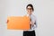 Image of pleased office woman wearing eyeglasses holding yellow copyspace placard, isolated over white background