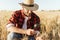 Image of pleased unshaven adult man examining harvest with magnifier