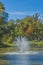 Image of a pond with a fountain with reflection in the water