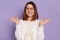 Image of positive satisfied delighted young adult Caucasian woman wearing white shirt, practicing yoga, relaxing, keeps eyes