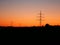 Image of power pylons in the landscape during colorful sunset