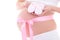 Image of pregnant woman tummy with pink ribbon and baby\'s bootee