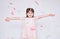 Image of pretty little girl wearing pink dress in tulle with princess crown on head on white background rise hands enjoy