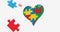 Image of puzzles falling over beating heart formed with autism awareness puzzles on white