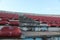 Image of red colored  rows  of spectators seats in a stadium with blue sky background