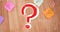 Image of red question marks over multicolour memo notes on wooden background