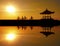 Image Reflection of cyclists riding on a concrete barrier in bali indonesia Sanur beach