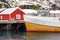 image representative for Lofoten Archipelago. Houses and a docked fishing boat.