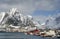 Image representative for Reine Resort. Winter in Lofoten Archipelago. Houses and a docked fishing boat.