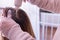 Image representing personal care at home. Hands of a person dying the hair of a woman in blond color. Indoors. Close up photo of