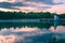 Image of reservoir lake with water reflections during sunset