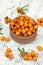 Image of ripe sea-buckthorn berries in wooden bowl