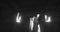 Image of scary zombie mummy walking in dark room with burning torches, in black and white