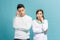 Image of serious thinking young loving couple isolated over light blue wall background looking aside