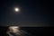 Image of the shore of the sea in the light of the moon