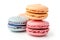 This image showcases a some of vibrant macarons, each representing a different flavor, isolated against a white background