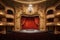 This image showcases a traditional theater with a striking red curtain and a stunning chandelier, creating a sophisticated