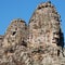 Image showcasing stone human faces on the towers of the Khmer Bayon Temple