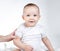 Image of sitting eleven-month-old baby on a white background