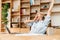 Image of sleepy woman yawning while working with papers and laptop