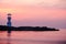 Image of small lighthouse against a tropical ocean sunset and smooth water at Khao Lak Beach in Phang Nga,Thailand.