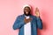 Image of smiling african-american man being honest, telling truth, hands on heart and in air, making promise or swearing