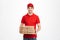 Image of smiling deliveryman in red t-shirt and cap holding stack of pizza boxes, isolated over white background