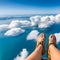 image of someone sitting on high area with bird\\\'s eye view looking down on the landscape below with a pair of legs in view