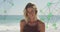 Image of spinning networks with social media digital icons over smiling woman on beach