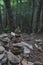 Image of spiritual stones pyramid in the misterious dark forest on Sakhalin island.