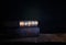 image of stack of antique books over wooden table and dark background.