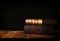 image of stack of antique books over wooden table and dark background.