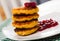 Image of stack of fried quark pancakes with jam served
