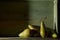 Image of Still Life with a stack of green Pears. Rustic wood background, antique wooden table
