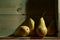 Image of Still Life with a stack of green Pears. Rustic wood background, antique wooden table