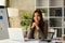 Image of successful startup business founder sitting in modern office and smiling at camera