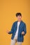 Image Successful young Asian man On orange background. Looking at camera