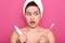 Image of surprised lady with opened mouth, holding toothpaste and toothbrush in hands, posing in bathroom, brushes teeth in