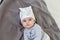 Image of sweet baby girl in a cute hat, closeup portrait of cute 6 month old smiling girl, toddler.