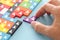 Image of tangram puzzle blocks with people icons over wooden table ,human resources and management concept.