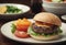 In this image, a tasty hamburger is presented on a plate, accompanied by fresh and bright vegetables.