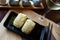 Image of tasty triangular onigiri from rice at black plate