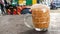 An image of teh tarik or also known as tea with milk served in a glass