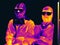 Image in the thermal imager of two people in masks and glasses. Infrared Thermal image people. concept of the coronavirus epidemic