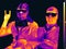 Image in the thermal imager of two people in masks and glasses. Infrared Thermal image people. concept of the coronavirus epidemic