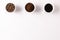Image of three cups full of ground coffee, coffee beans and coffee on white background