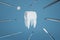 Image of a tooth on a blue background with a dentist's tools. 3D rendering.