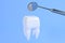 Image of a tooth on a blue background with a dentist tool. 3D rendering